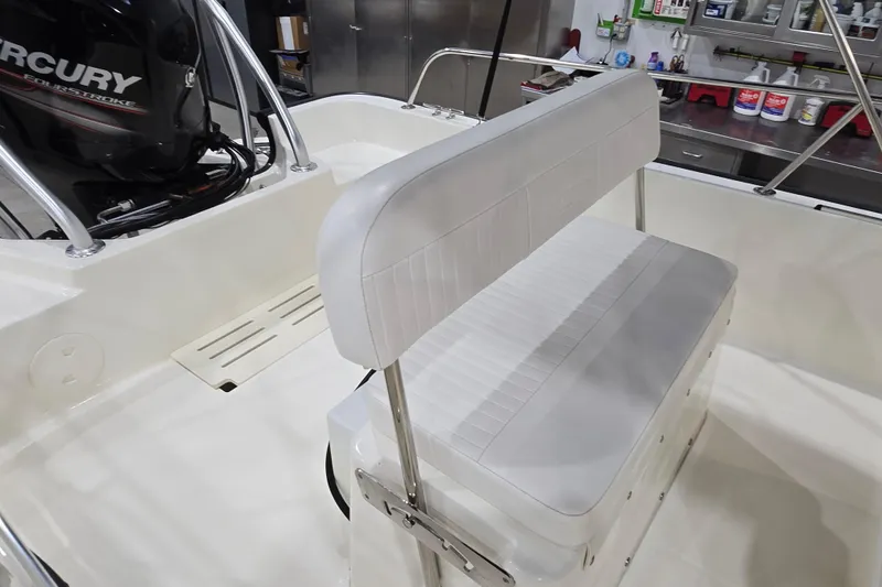 Slide: The Image of 2014 Boston Whaler 170 Montauk boat interior with Mercury engine and white seating. - 11