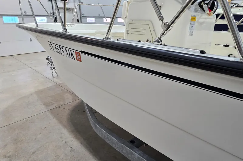 Slide: The Image of 2014 Boston Whaler 170 Montauk boat in garage, side view with registration number. - 18