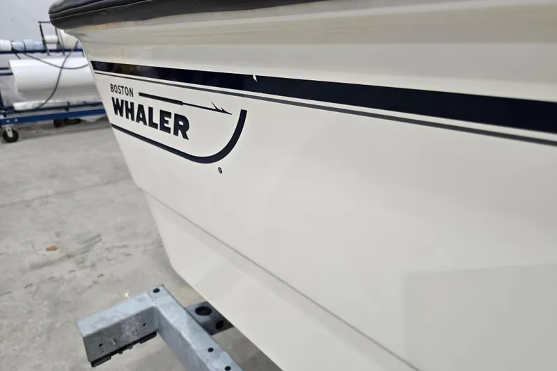 Slide: The Image of 2014 Boston Whaler 170 Montauk boat side view in a garage setting. - 24