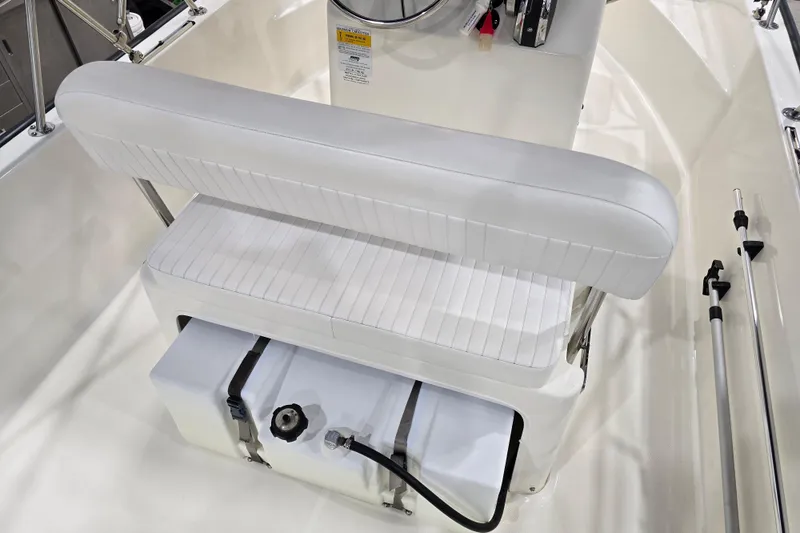 Slide: The Image of 2014 Boston Whaler 170 Montauk boat interior with white seating and storage compartment. - 28