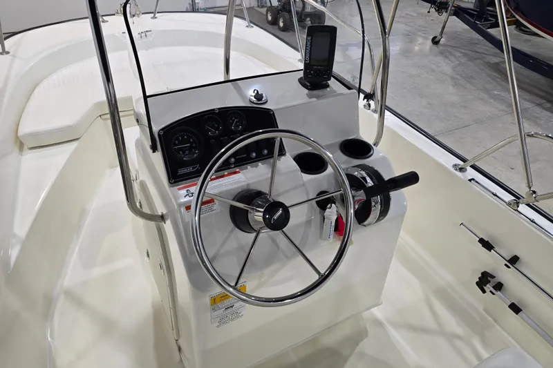 Slide: The Image of 2014 Boston Whaler 170 Montauk boat console with steering wheel and navigation equipment. - 29