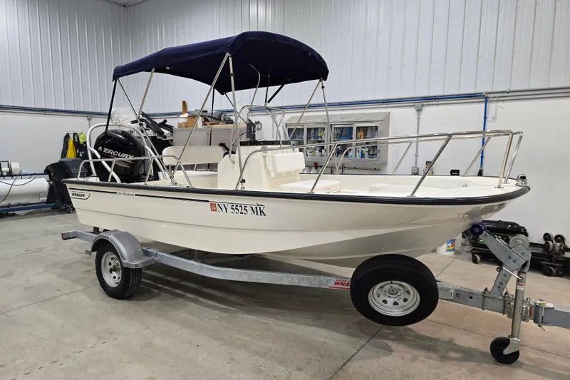 Slide: The Image of 2014 Boston Whaler 170 Montauk boat on trailer in indoor storage. - 3