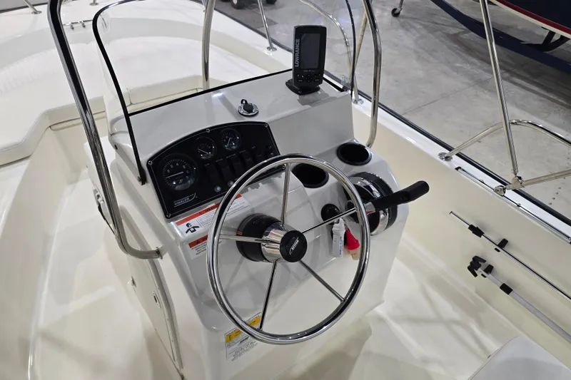Slide: The Image of 2014 Boston Whaler 170 Montauk boat console with steering wheel and navigation equipment. - 30