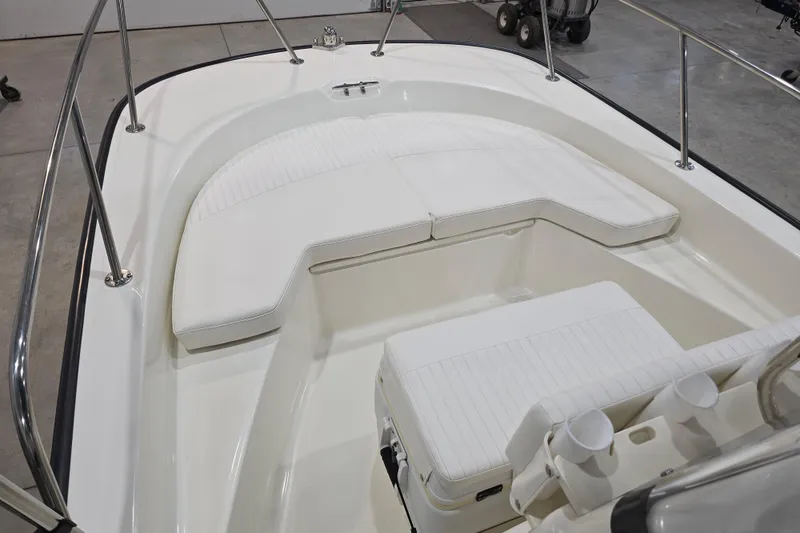 Slide: The Image of 2014 Boston Whaler 170 Montauk boat interior with white seating and stainless steel railings. - 31