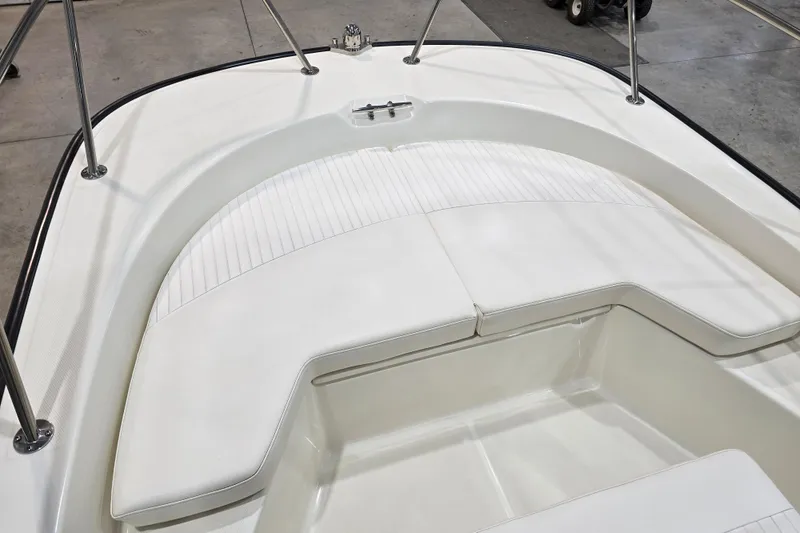 Slide: The Image of 2014 Boston Whaler 170 Montauk boat interior with white cushioned seating. - 32