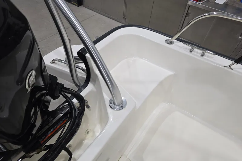 Slide: The Image of 2014 Boston Whaler 170 Montauk boat interior with motor and stainless steel railings. - 40