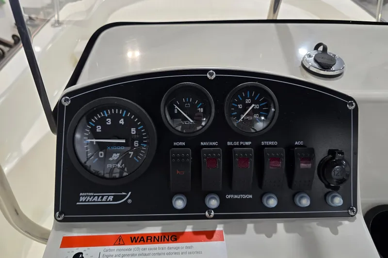 Slide: The Image of 2014 Boston Whaler 170 Montauk dashboard with gauges and switches. - 43
