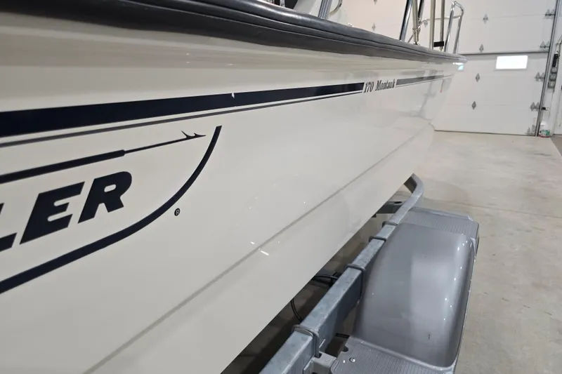 Slide: The Image of 2014 Boston Whaler 170 Montauk boat on trailer in garage. - 45