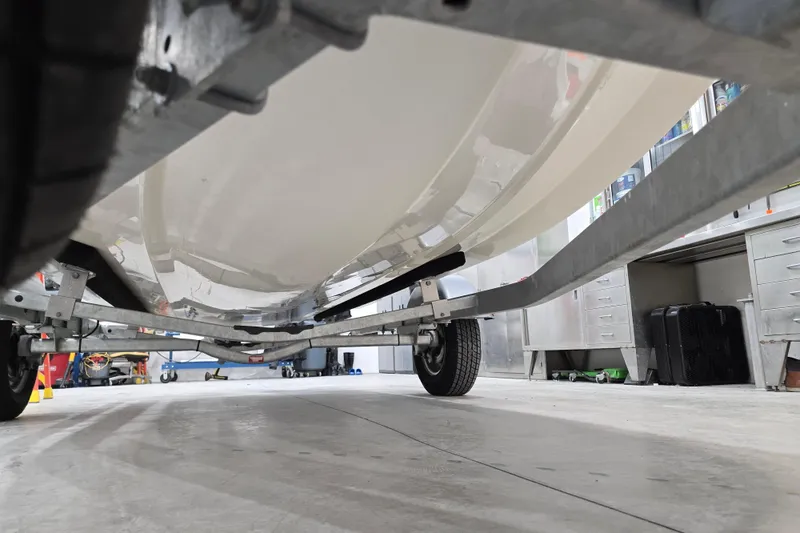 Slide: The Image of Underneath view of a 2014 Boston Whaler 170 Montauk on a trailer in a garage. - 47