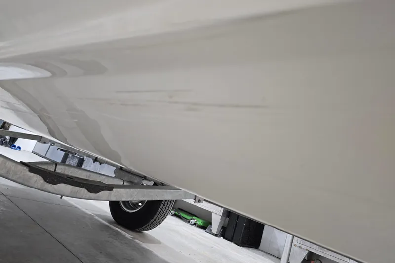 Slide: The Image of 2014 Boston Whaler 170 Montauk boat hull with visible scratches on trailer. - 48