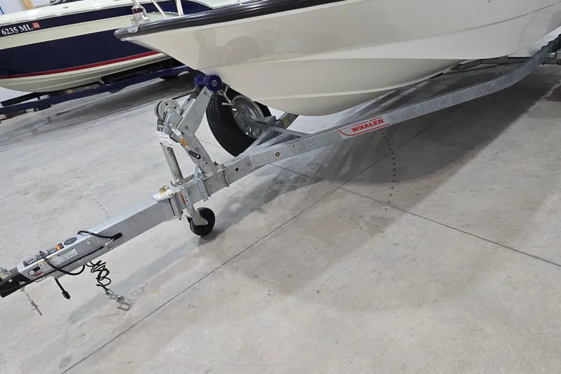 Slide: The Image of 2014 Boston Whaler 170 Montauk boat on trailer in a garage setting. - 6