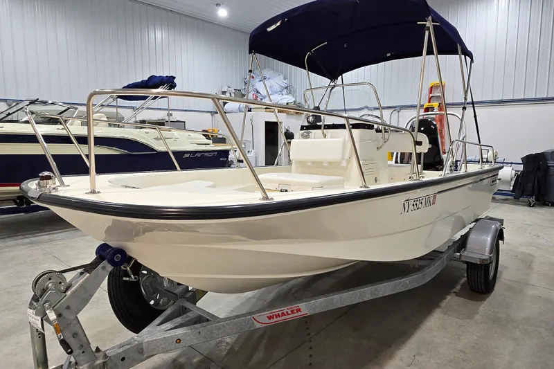 Slide: The Image of 2014 Boston Whaler 170 Montauk boat on trailer in indoor storage facility. - 7
