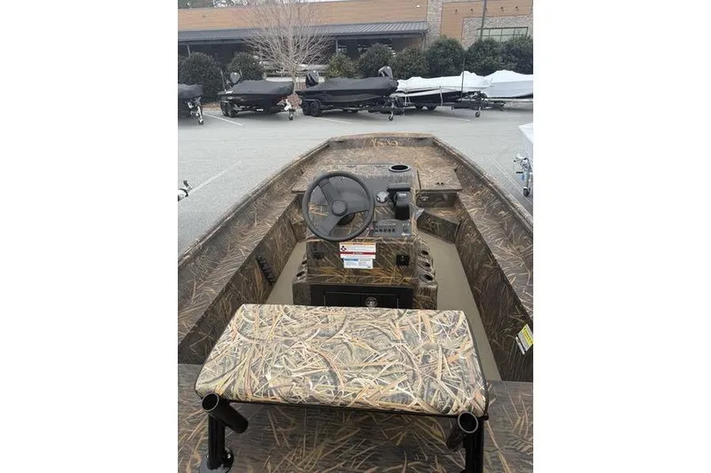 Slide: The Image of 2026 G3 Gator Tough 17 CC boat with camo interior, steering wheel, and control panel. - 6