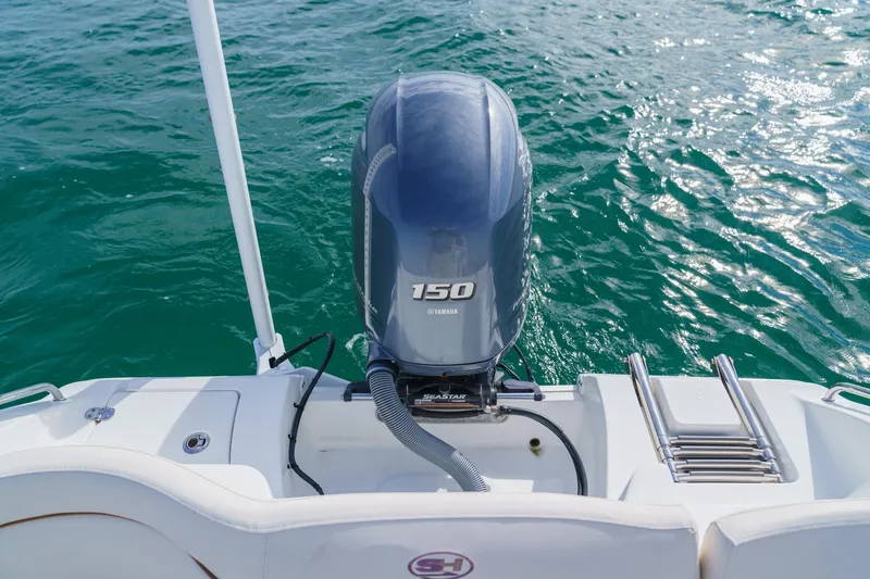Slide: The Image of 2022 Sea Hunt Ultra 219 boat with Yamaha 150 engine on open water. - 15