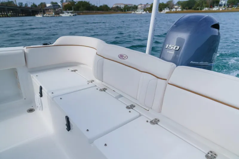 Slide: The Image of 2022 Sea Hunt Ultra 219 boat interior with Yamaha 150 engine on water. - 21