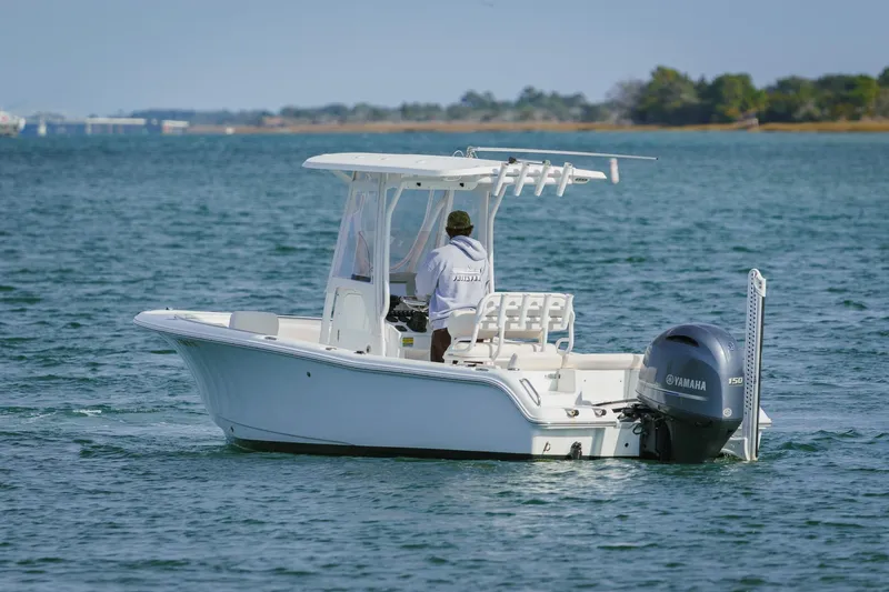 Slide: The Image of 2022 Sea Hunt Ultra 219 boat cruising on a calm lake with Yamaha engine. - 3