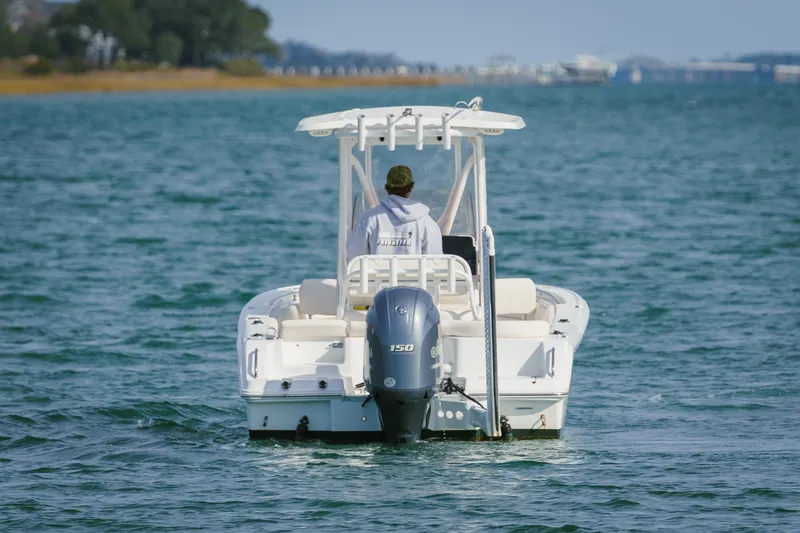 Slide: The Image of 2022 Sea Hunt Ultra 219 boat cruising on open water, rear view. - 4