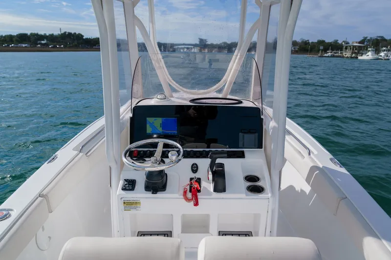 Slide: The Image of 2022 Sea Hunt Ultra 219 boat dashboard with steering wheel and navigation system. - 8