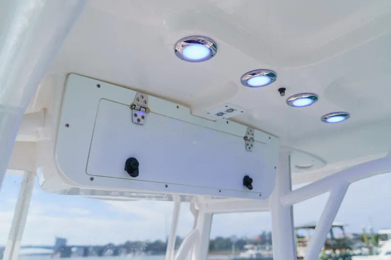 Slide: The Image of 2022 Sea Hunt Ultra 219 boat interior with LED lights and storage compartment. - 9