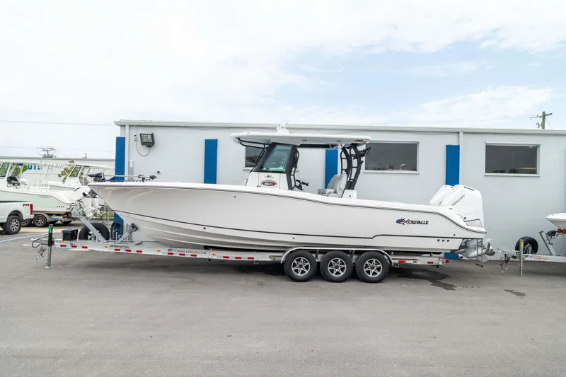 The Image of 2026 Crevalle 33 CSF boat on a trailer, parked outside a building. - 0