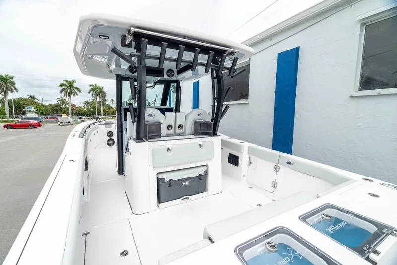 Slide: The Image of 2026 Crevalle 33 CSF boat with sleek design and modern features, docked near palm trees. - 11
