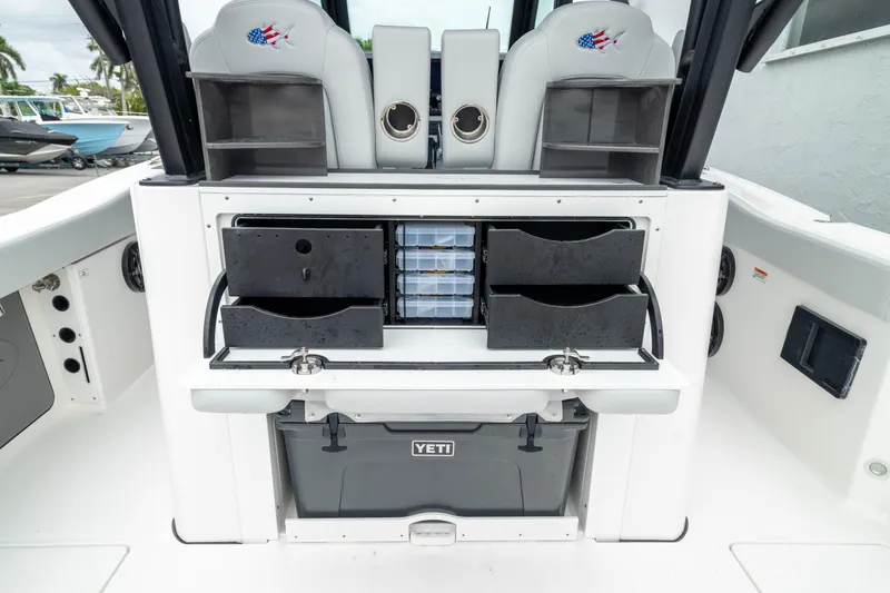 Slide: The Image of 2026 Crevalle 33 CSF boat interior with storage compartments and Yeti cooler. - 12