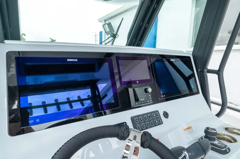 Slide: The Image of 2026 Crevalle 33 CSF boat dashboard with advanced navigation displays and controls. - 15