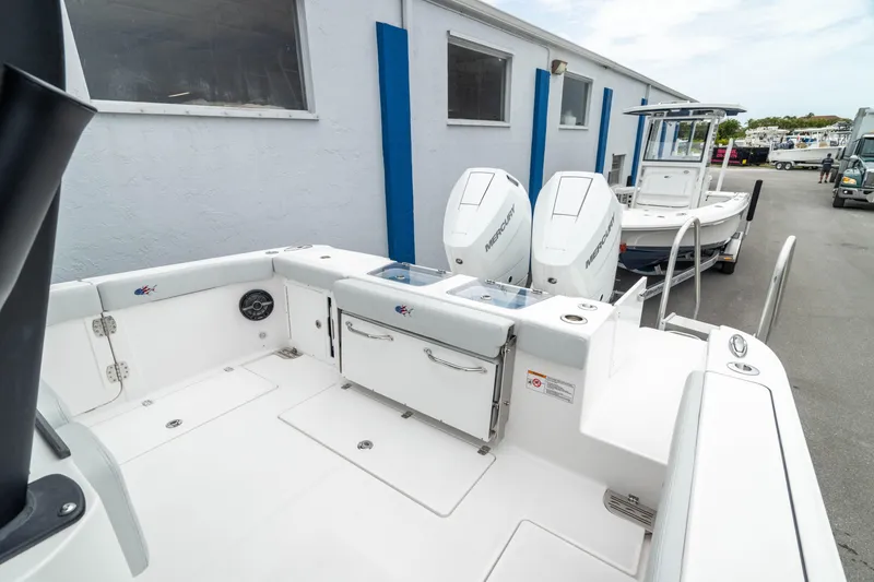 Slide: The Image of 2026 Crevalle 33 CSF boat with dual engines, docked near a building. - 19