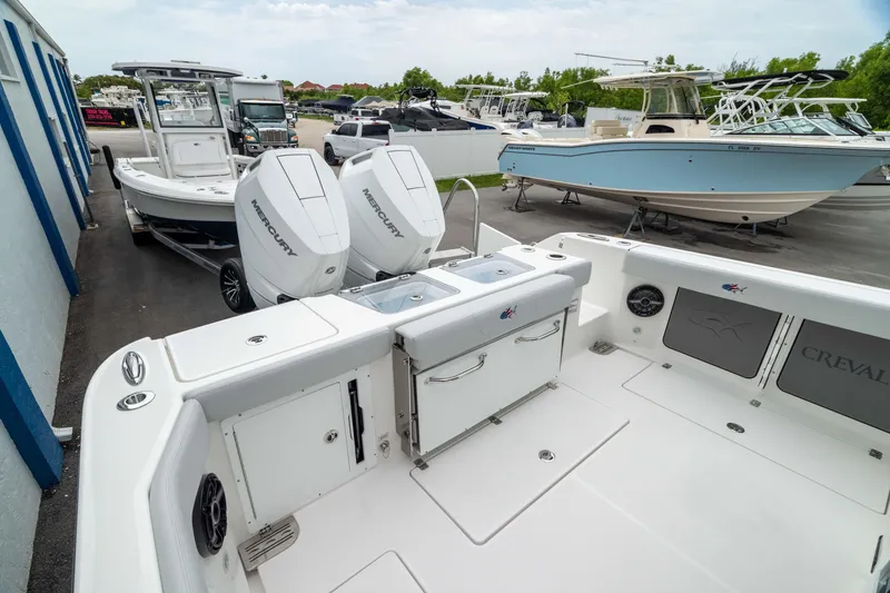 Slide: The Image of 2026 Crevalle 33 CSF boat with dual Mercury outboard engines, docked at a marina. - 20