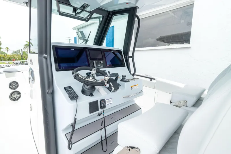 Slide: The Image of 2026 Crevalle 33 CSF boat cockpit with modern navigation equipment and steering wheel. - 31