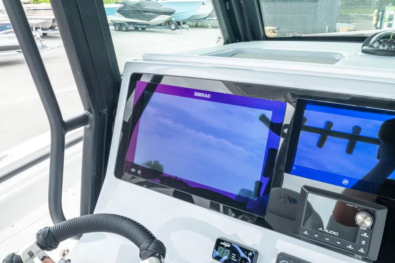 Slide: The Image of Dashboard of 2026 Crevalle 33 CSF boat with Simrad display and controls. - 36