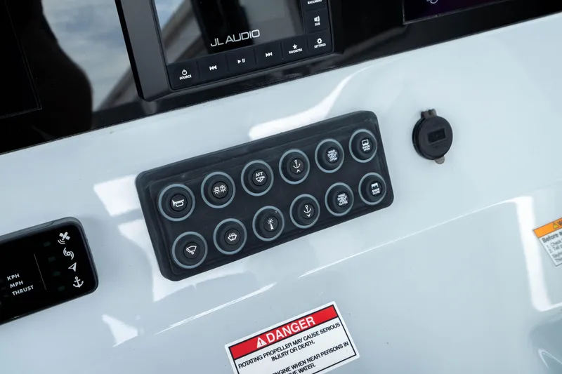Slide: The Image of Control panel of 2026 Crevalle 33 CSF boat with various buttons and warning label. - 41