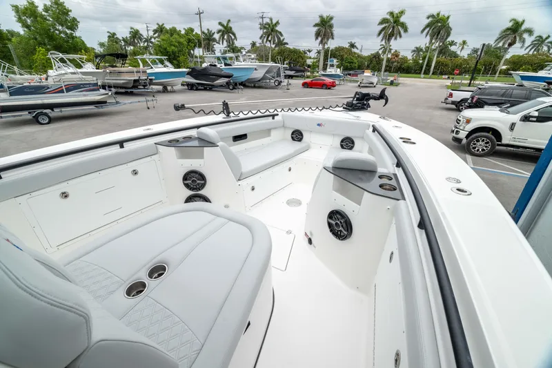 Slide: The Image of 2026 Crevalle 33 CSF boat interior with seating and speakers in a marina setting. - 6