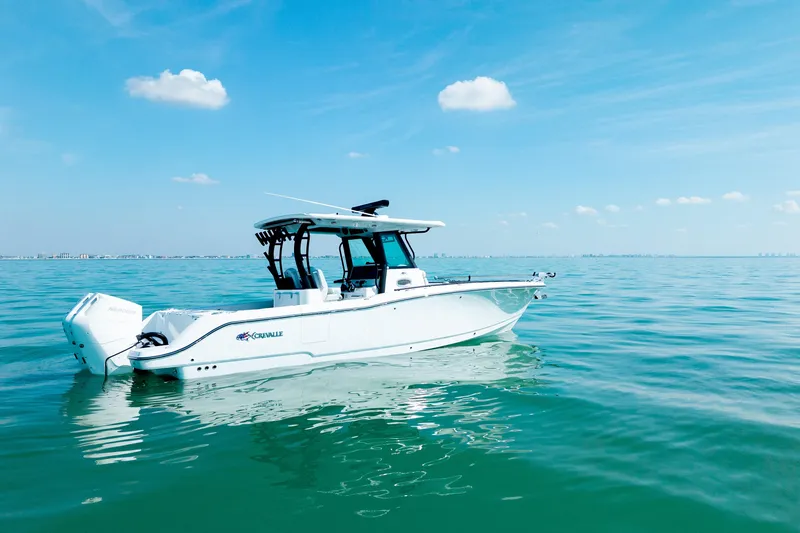 Slide: The Image of 2026 Crevalle 33 CSF boat on calm blue water under clear sky. - 10