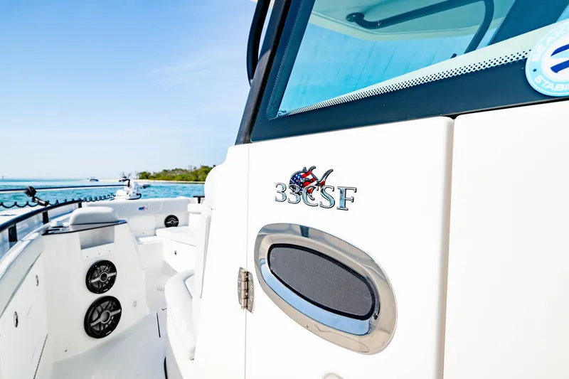 Slide: The Image of 2026 Crevalle 33 CSF boat interior with logo, speakers, and ocean view. - 13
