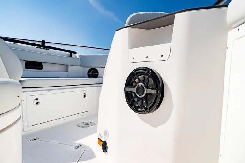 Slide: The Image of 2026 Crevalle 33 CSF boat interior with speaker and seating, under clear blue sky. - 15
