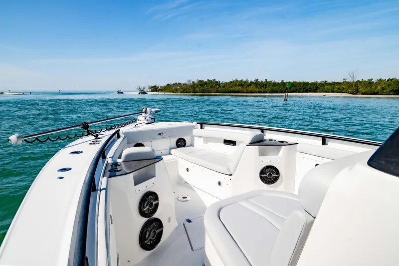 Slide: The Image of 2026 Crevalle 33 CSF boat interior with seating, speakers, and scenic water view. - 2