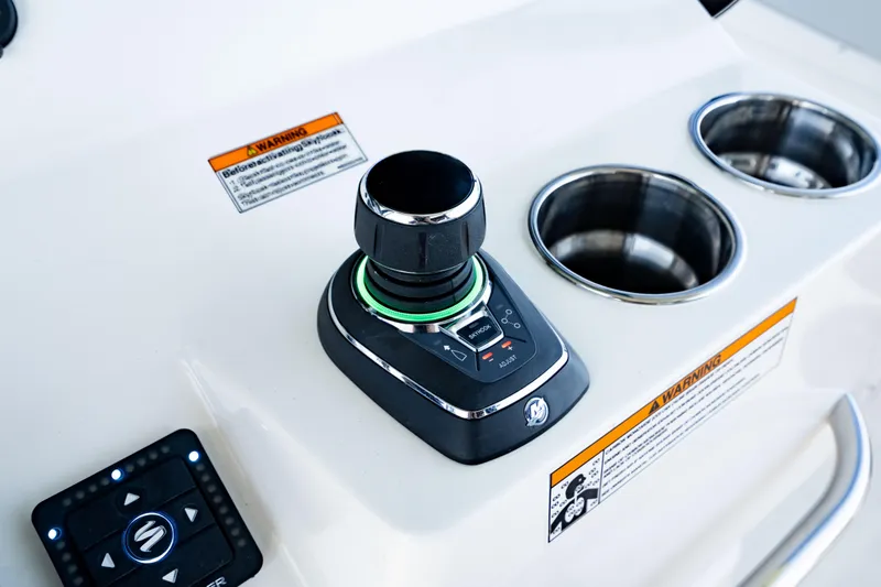 Slide: The Image of Joystick control panel on 2026 Crevalle 33 CSF boat with cup holders and warning labels. - 21