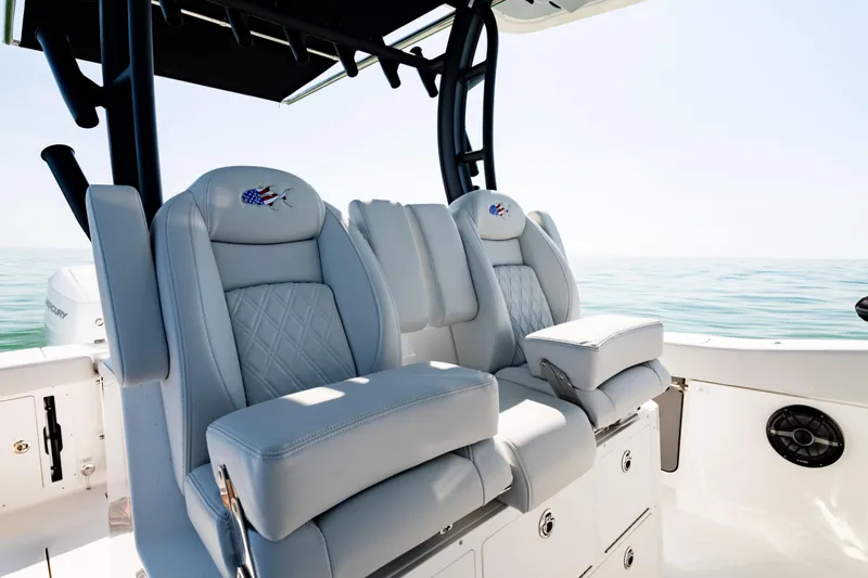 Slide: The Image of Luxury seating on 2026 Crevalle 33 CSF boat, featuring premium upholstery and ocean backdrop. - 25