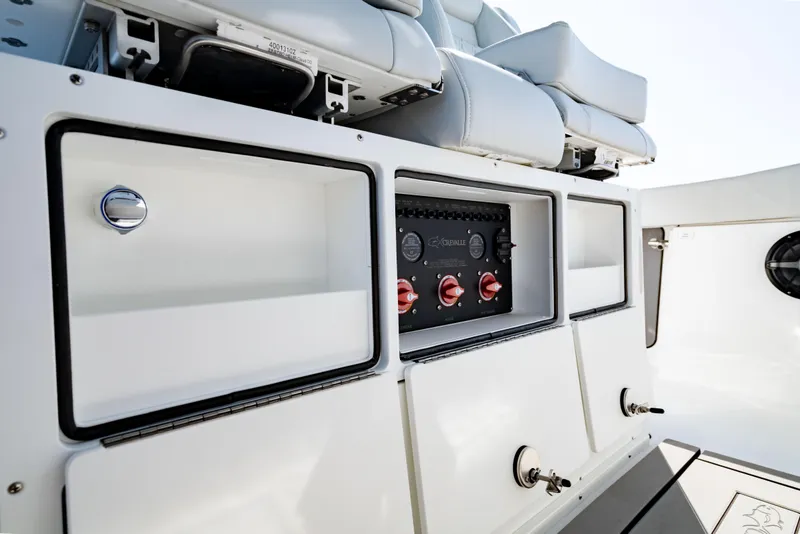 Slide: The Image of 2026 Crevalle 33 CSF boat interior with storage compartments and control panel. - 26