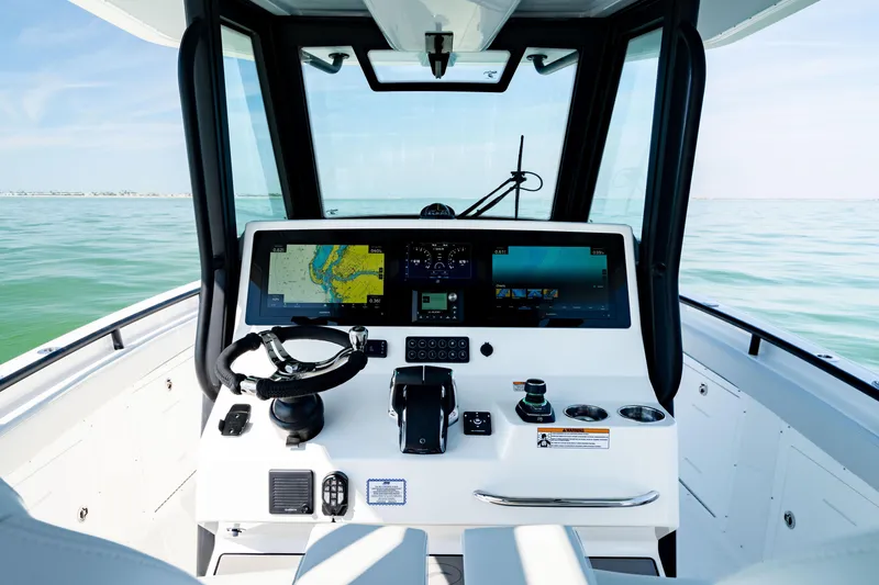 Slide: The Image of 2026 Crevalle 33 CSF boat cockpit with advanced navigation displays and steering wheel. - 28