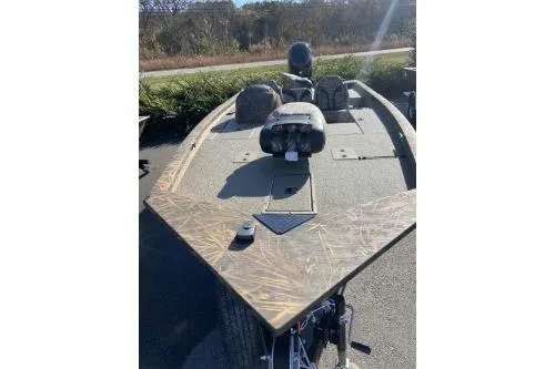 Slide: The Image of 2026 G3 Sportsman 1810 PFX Camo boat with camouflage design, parked outdoors. - 3