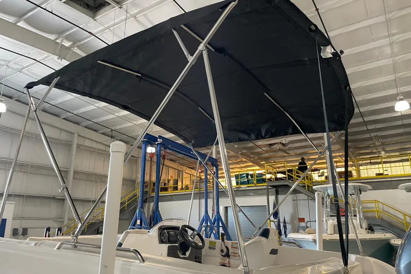 Slide: The Image of 2023 Hurricane SunDeck Sport 201 OB boat with Yamaha outboard motor, parked outdoors. - 12