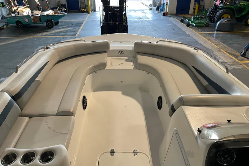 Slide: The Image of 2023 Hurricane SunDeck Sport 201 OB boat canopy against a blue sky background. - 14