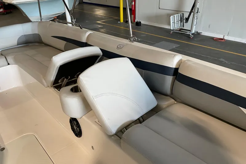 Slide: The Image of 2023 Hurricane SunDeck Sport 201 OB boat seating with cup holders and beige upholstery. - 18
