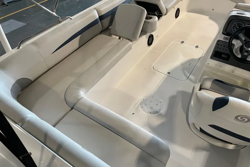 Slide: The Image of 2023 Hurricane SunDeck Sport 201 OB boat interior with beige seating and cup holders. - 20