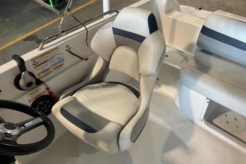 Slide: The Image of 2023 Hurricane SunDeck Sport 201 OB boat dashboard with steering wheel and controls. - 22