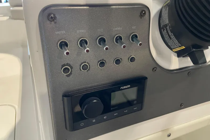 Slide: The Image of 2023 Hurricane SunDeck Sport 201 OB boat controls with capacity warning labels. - 25