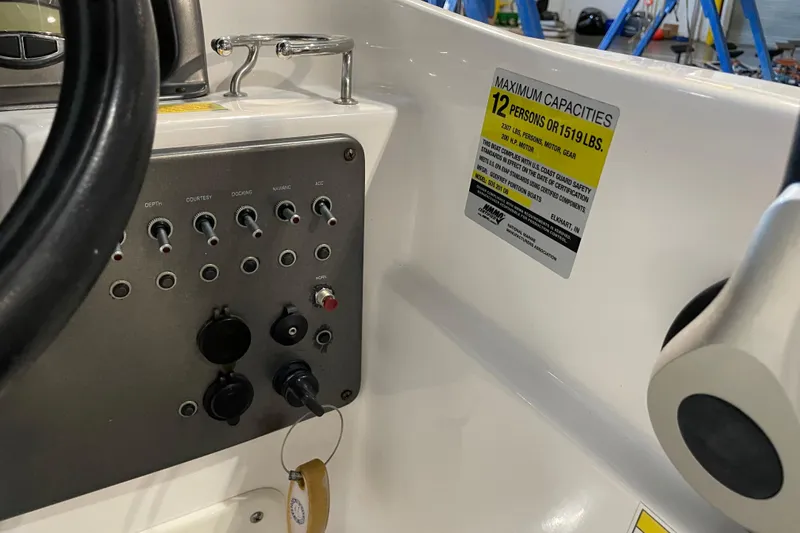 Slide: The Image of 2023 Hurricane SunDeck Sport 201 OB boat interior with beige seating and storage compartment. - 26