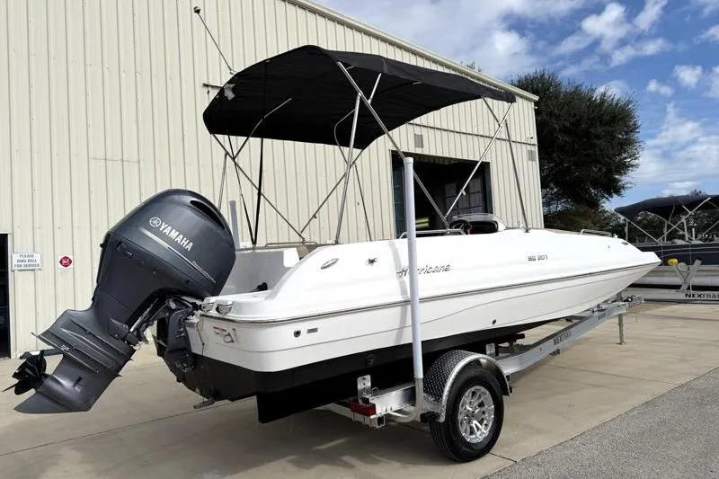 Slide: The Image of 2023 Hurricane SunDeck Sport 201 OB boat with Yamaha outboard motor on trailer. - 30